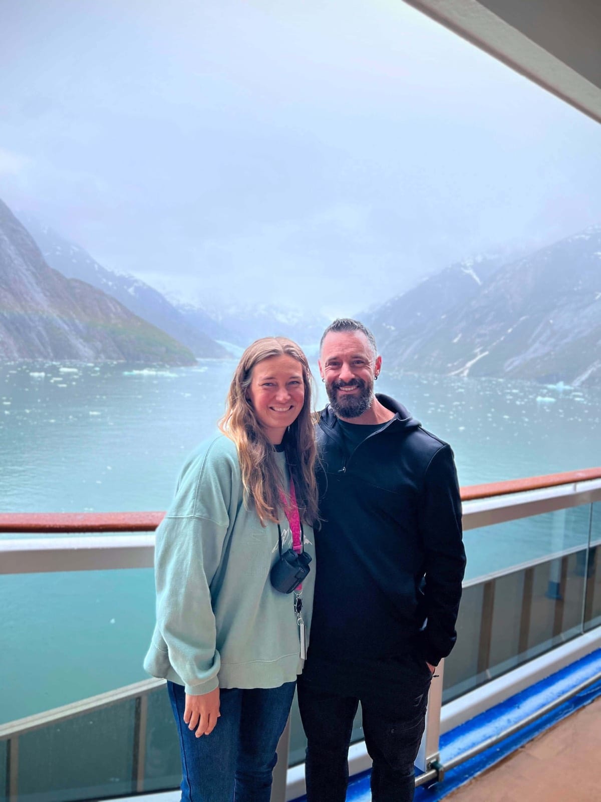 Becky and me on a ship deck in front of a glacier